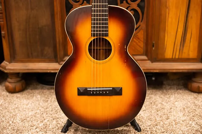 Sunburst front of a restored 1928 Gibson L1, with its bridge, soundhole and fingerboard visible.