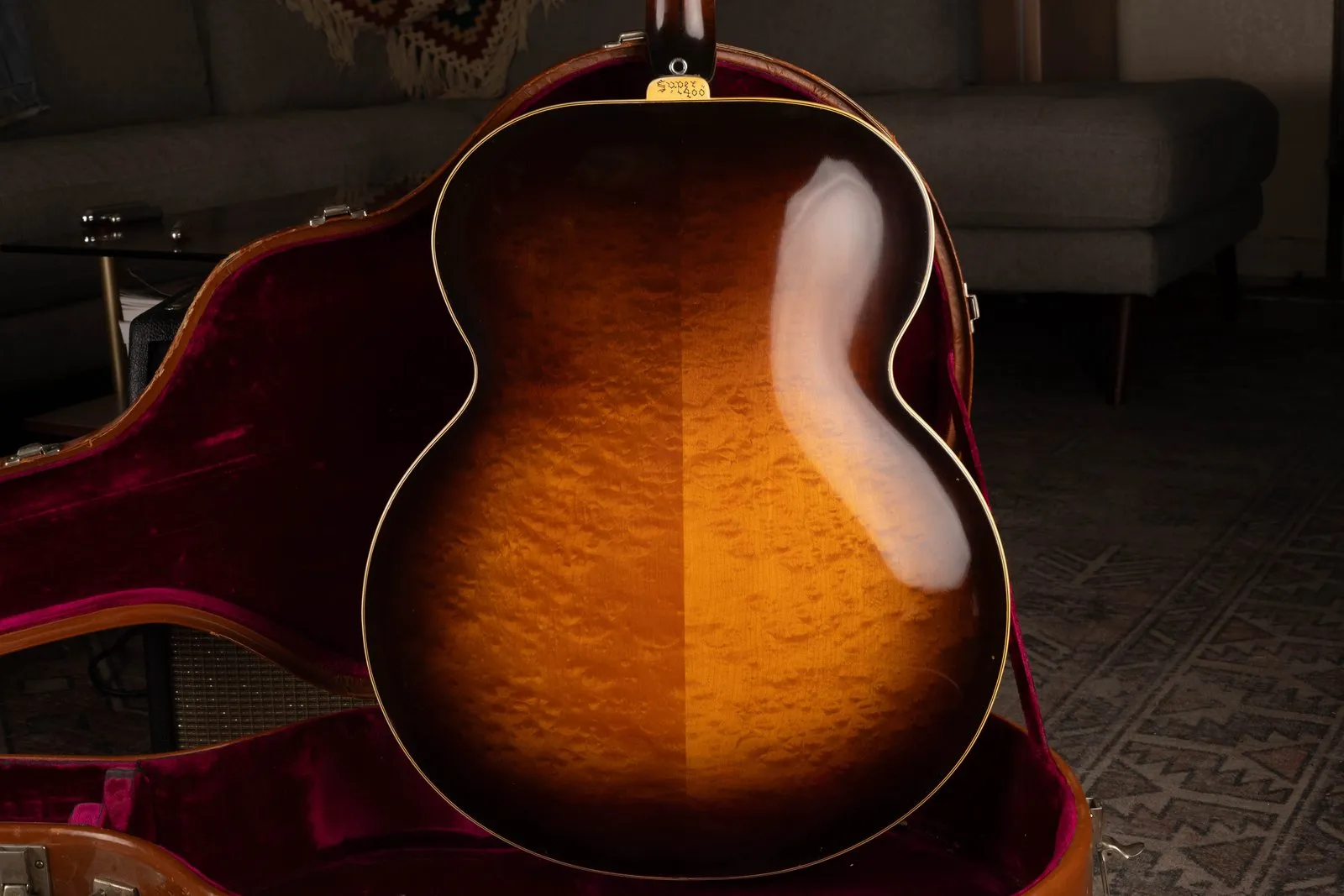Figured maple back of a 1938 Gibson Super 400, with a Super 400 heel cap and magenta case lining.
