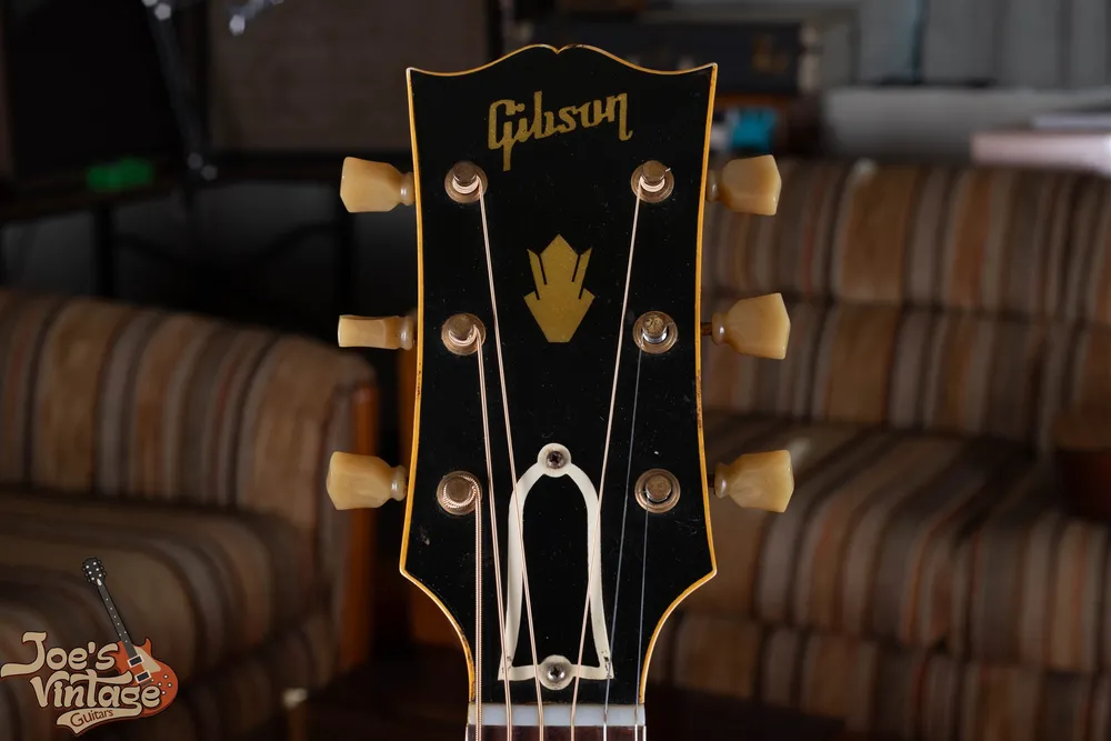 Bound headstock of a 1948 Gibson SJ-200 with script logo and crown inlay