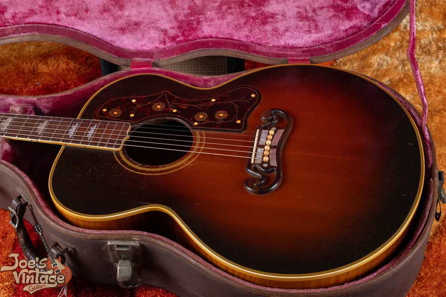 Sunburst J-200 body with a floral pickguard and moustache bridge in a pink-lined case