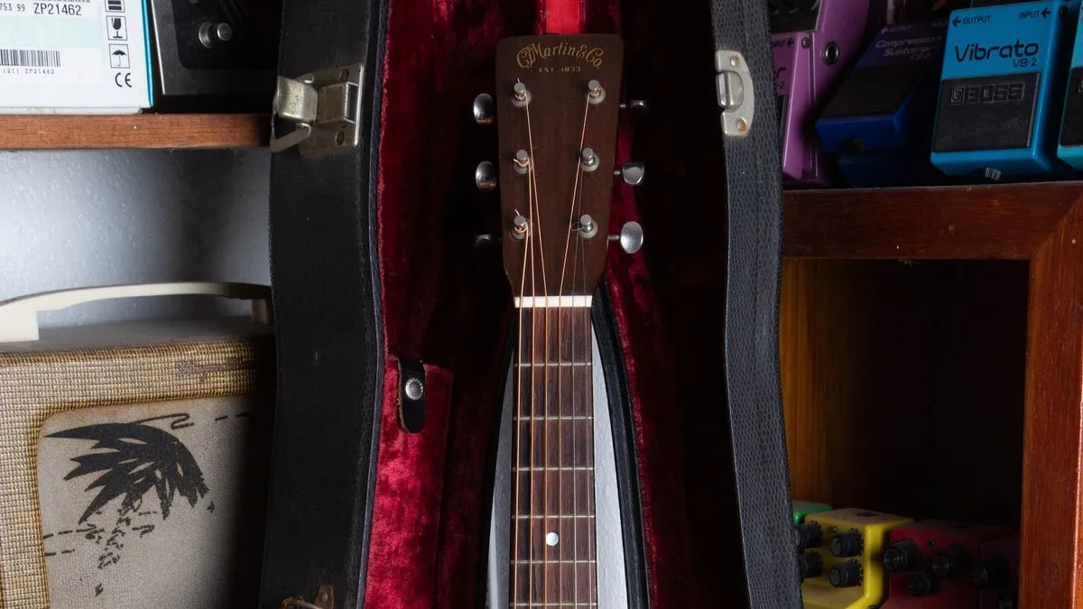 1950 Martin 5-18 solid peghead with the gold C.F. Martin and Co. Est. 1833 decal, resting in a red-lined hardshell case.