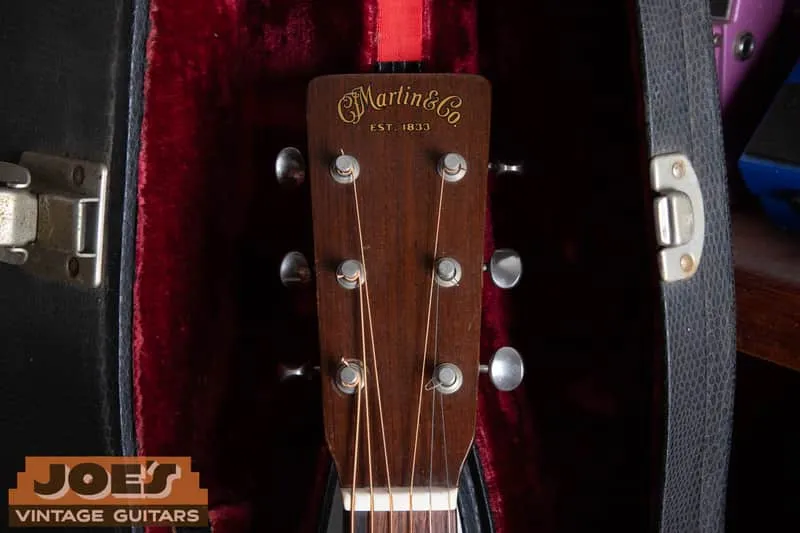 Solid peghead of a 1950 Martin 5-18 with the gold C.F. Martin and Co. Est. 1833 decal, in a red-lined case.