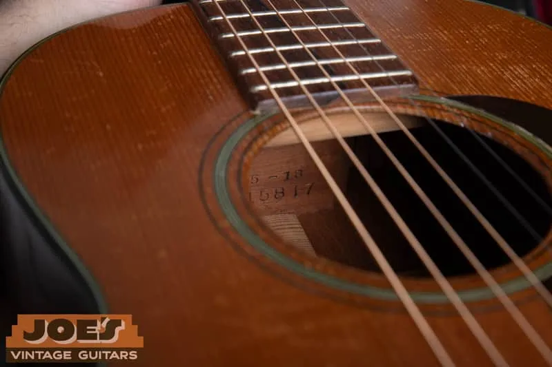Neck-block stamp inside a Martin soundhole reading 5-18 over serial 115817.