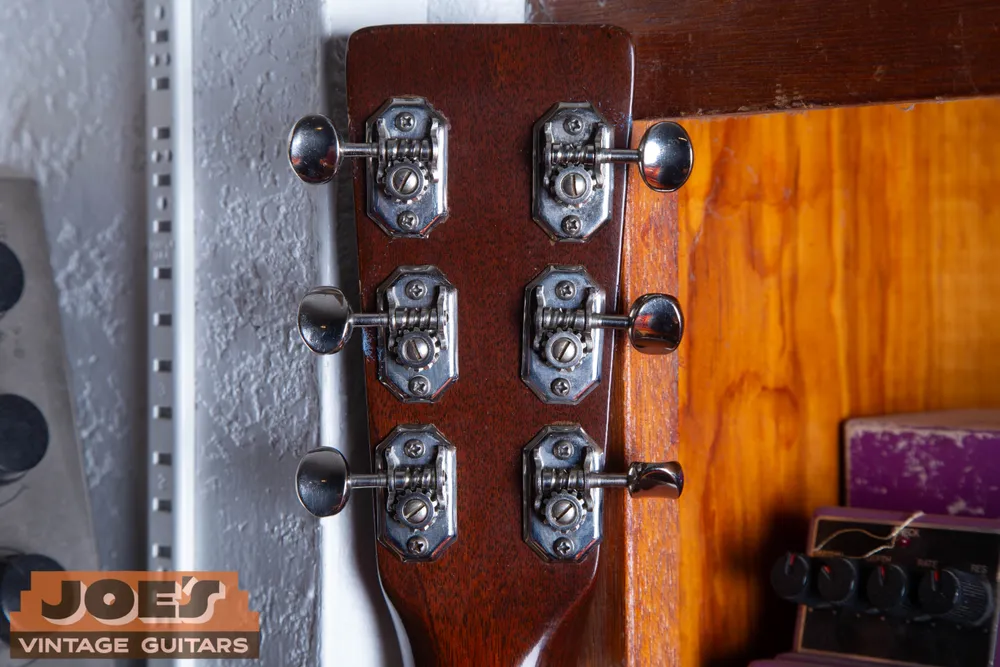 Open-gear tuners with broad octagonal baseplates, angled corners and metal buttons on a 1952 Martin 00-18