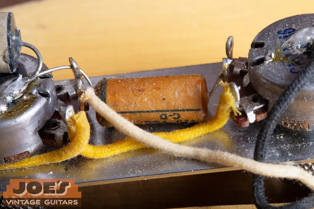 Original capacitor, wiring, pots, and switch in a 1952 Fender Telecaster