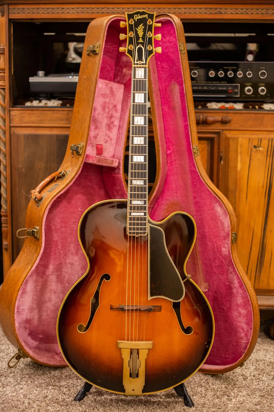 A 1954 Gibson L-5C displayed in its pink-lined hardshell case
