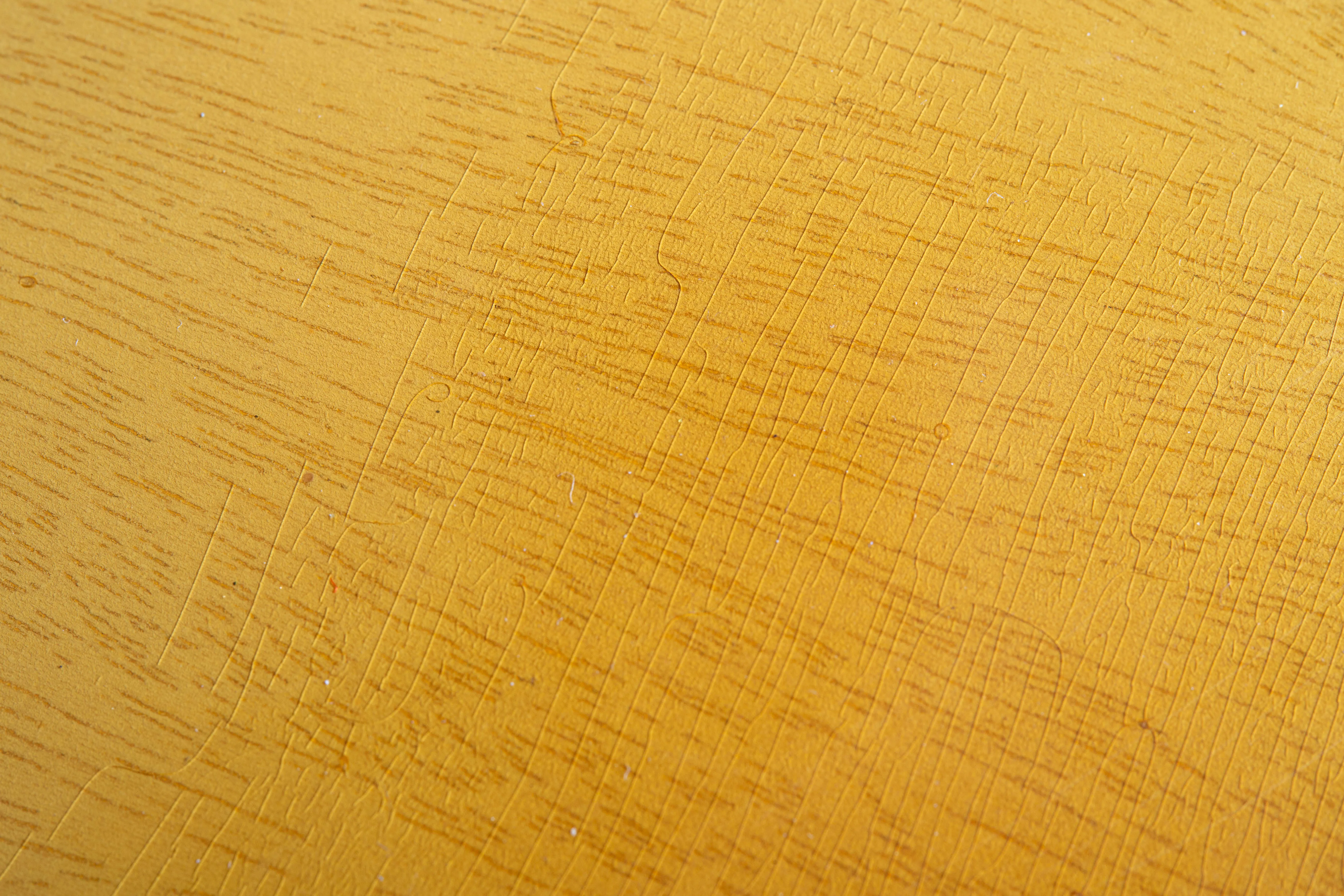Close view of TV Yellow finish with visible wood grain and crossing lacquer checks