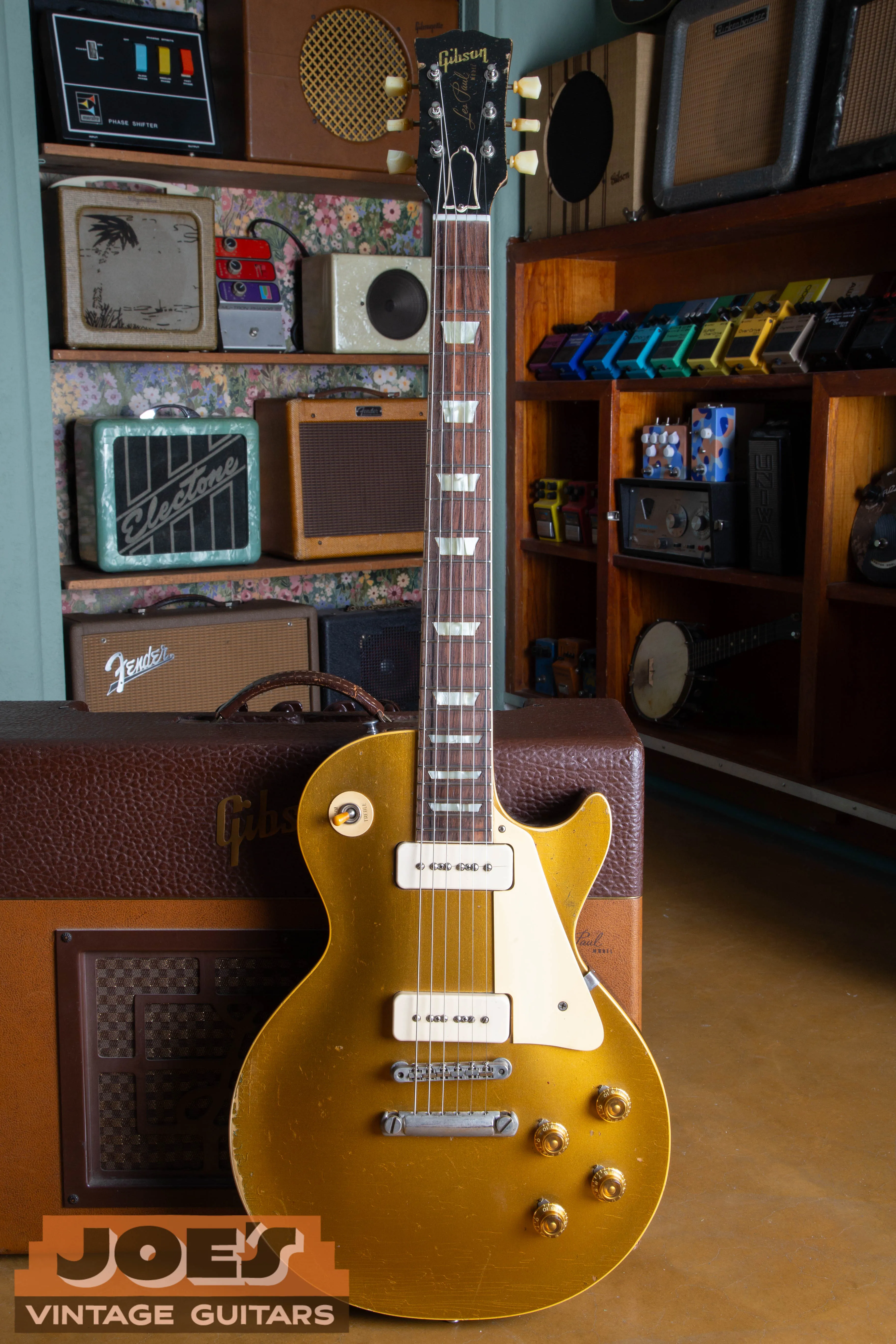 Full-body shot of an original 1956 Gibson Les Paul Goldtop with P-90 pickups and an ABR-1 bridge, showcasing the bullion gold finish and single-cutaway mahogany body.