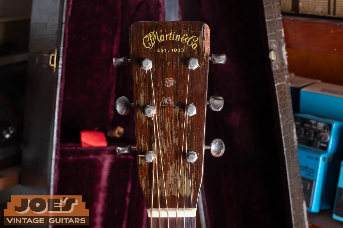 Close view of the worn Martin headstock logo and tuners on the 1956 000-21