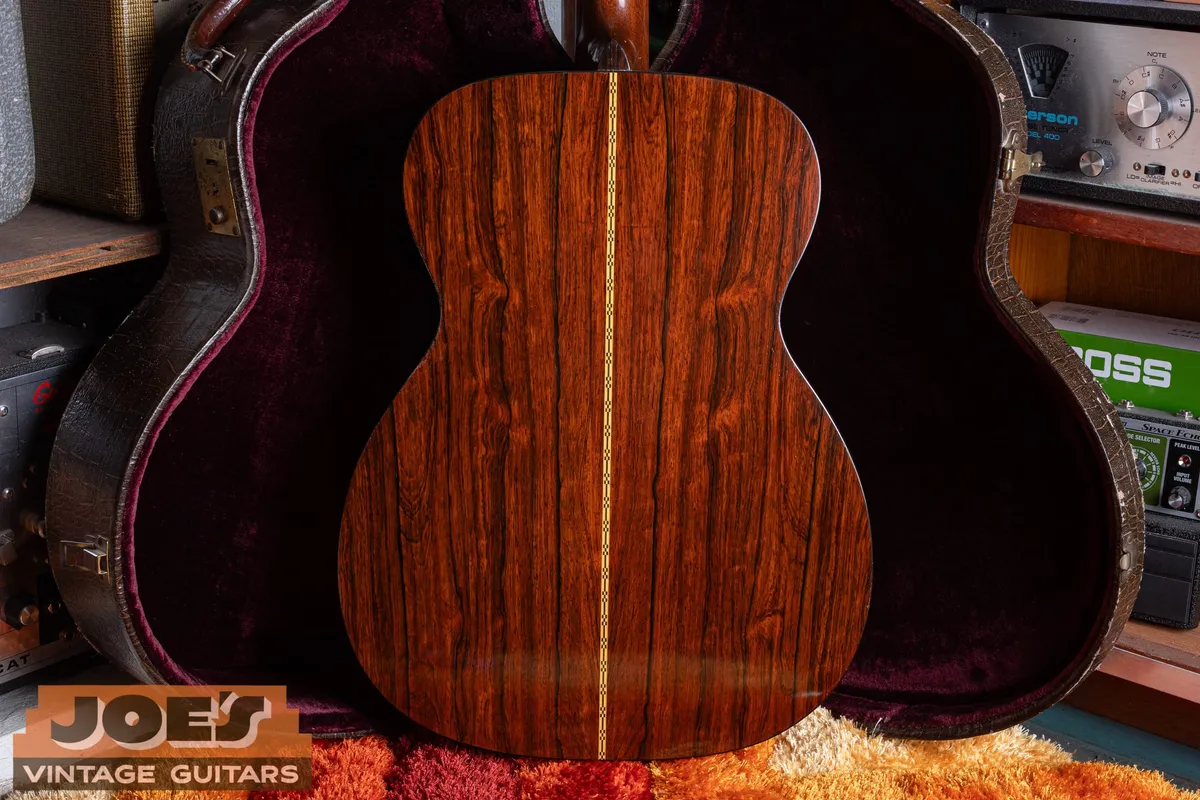 Full back view of the 1956 Martin 000-21 showing its figured dark rosewood and decorative center seam