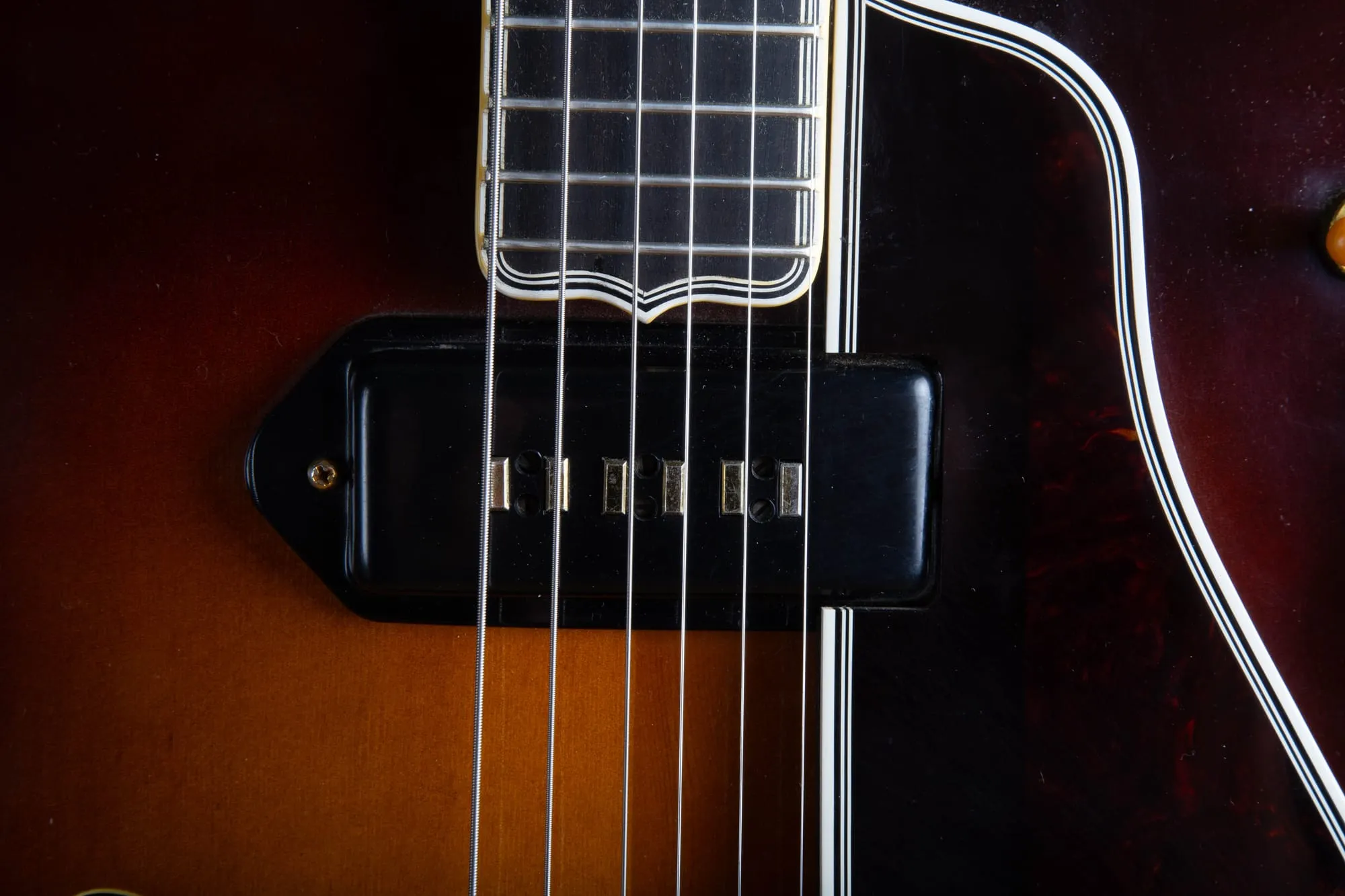 Close-up of a gold Alnico staple pickup on a 1957 Gibson Byrdland, showing the six rectangular staple magnets