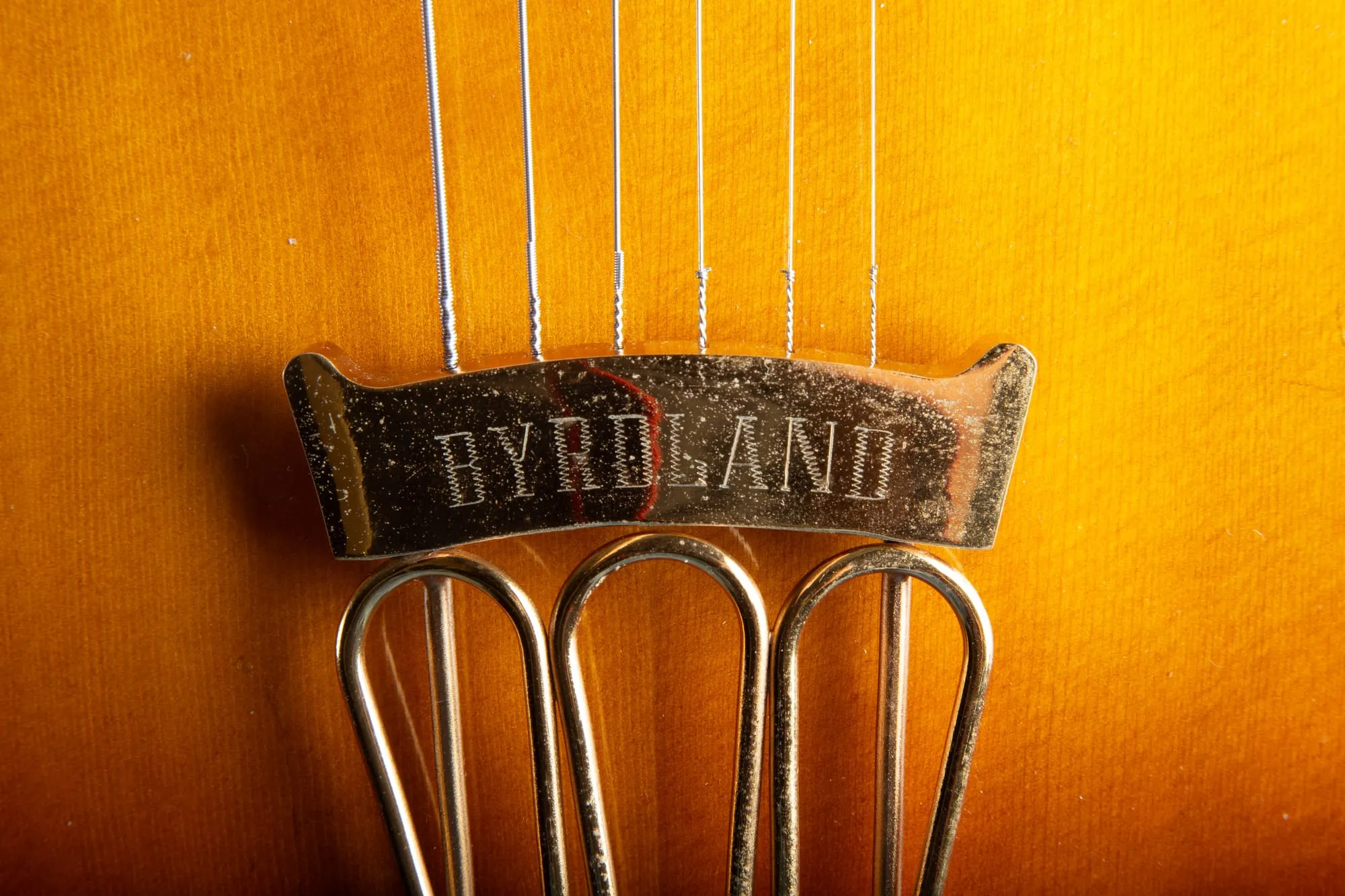 Gold engraved Byrdland tailpiece on a 1957 Gibson Byrdland, plating worn from decades of playing