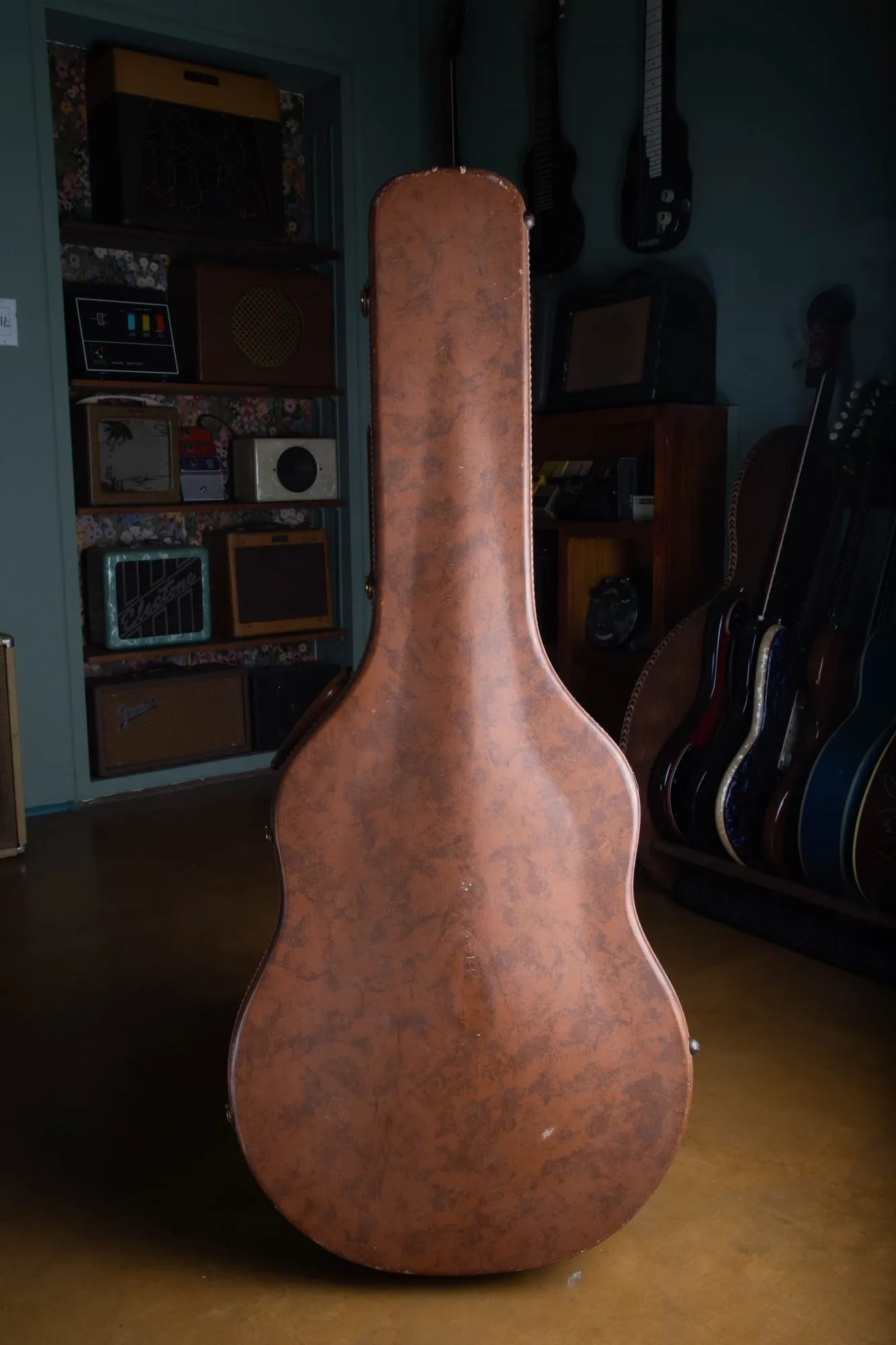 Original brown hardshell case for a 1957 Gibson Byrdland, closed, showing decades of honest wear