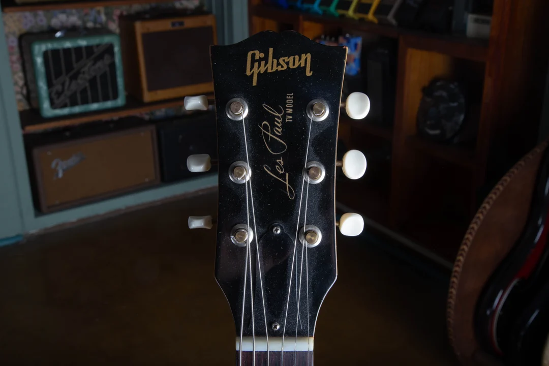 Front of a 1957 Gibson Les Paul TV Model headstock with cream-button strip tuners
