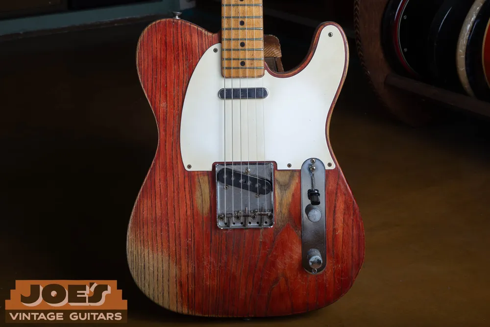 Refinished red 1958 Fender Telecaster showing a non-original non-blonde finish, white pickguard, and threaded bridge saddles