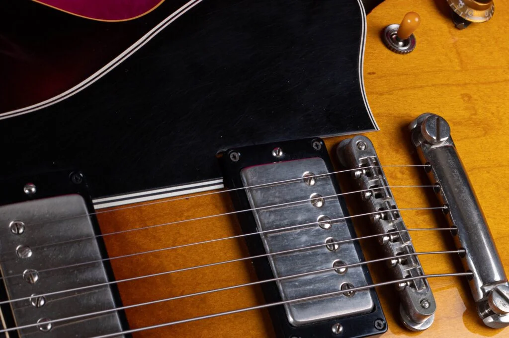 Long black ES-335 pickguard extending beside the ABR-1 bridge on a sunburst guitar