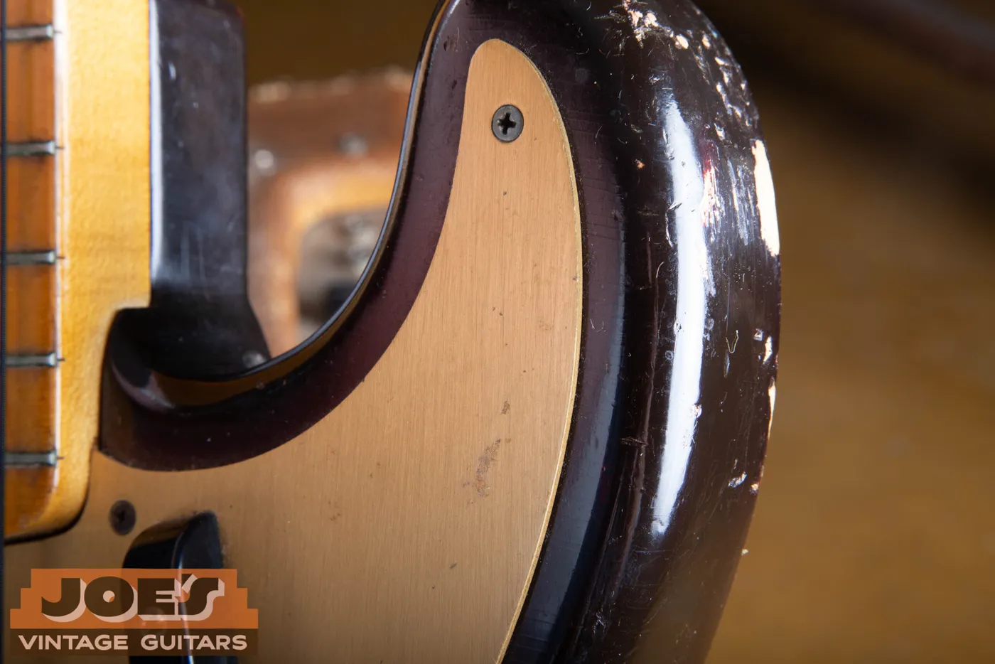 Close up of the gold anodized aluminum pickguard on a 1959 Fender Precision Bass
