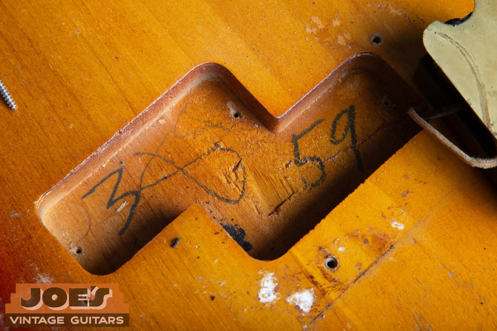 A penciled body date on a 1959 Fender Precision Bass body, written in the routing