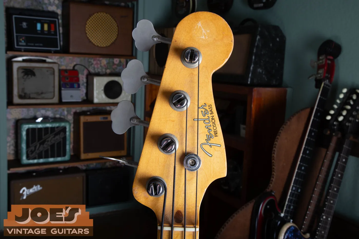 The front of the headstock on a 1959 Fender Precision Bass showing the thin spaghetti logo