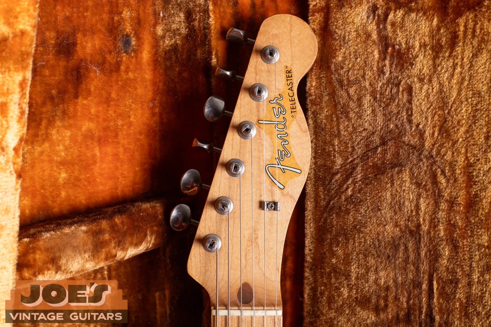 The headstock of a 1959 Fender Telecaster with the silver spaghetti logo and two patent numbers below the model name