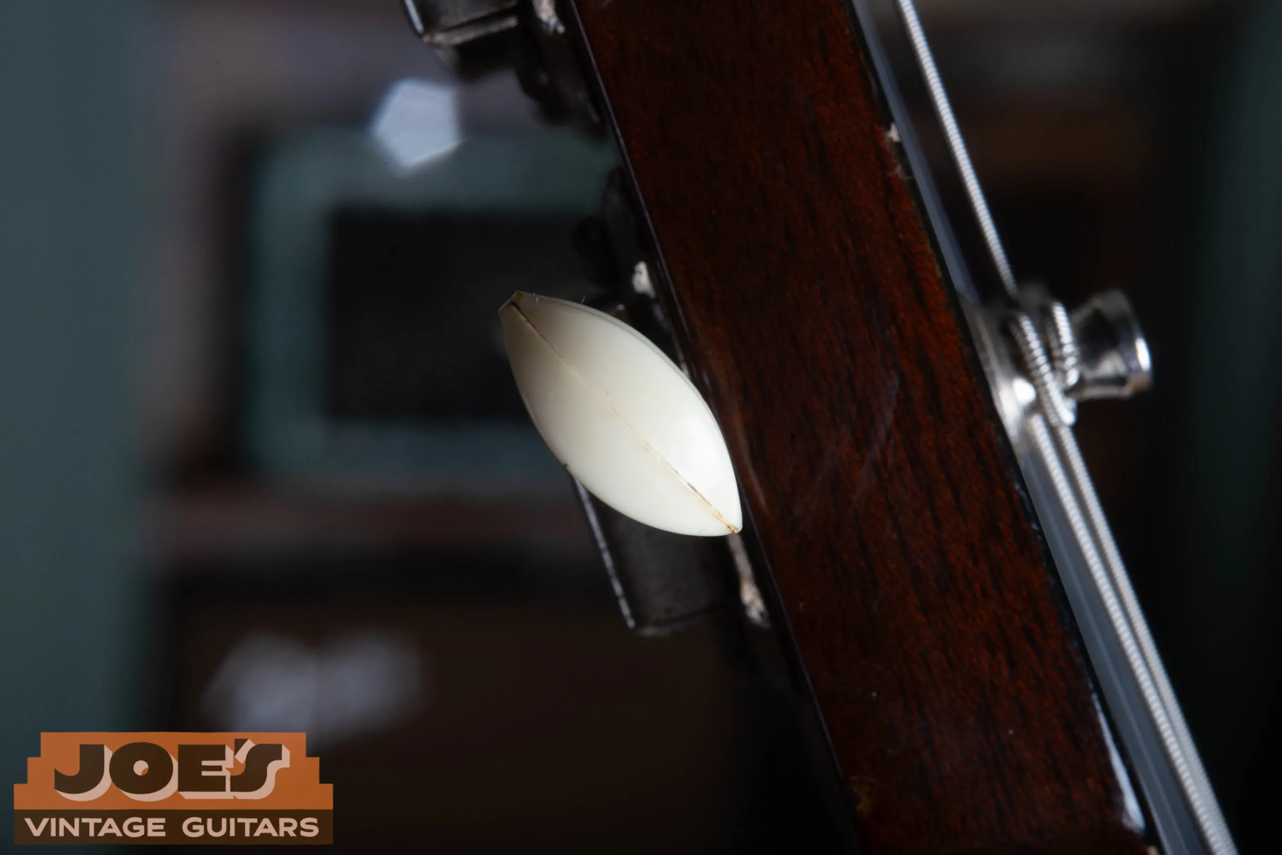 Close-up of a 1959 Gibson ES-330 Kluson tuner button showing the visible seam and appropriate celluloid aging