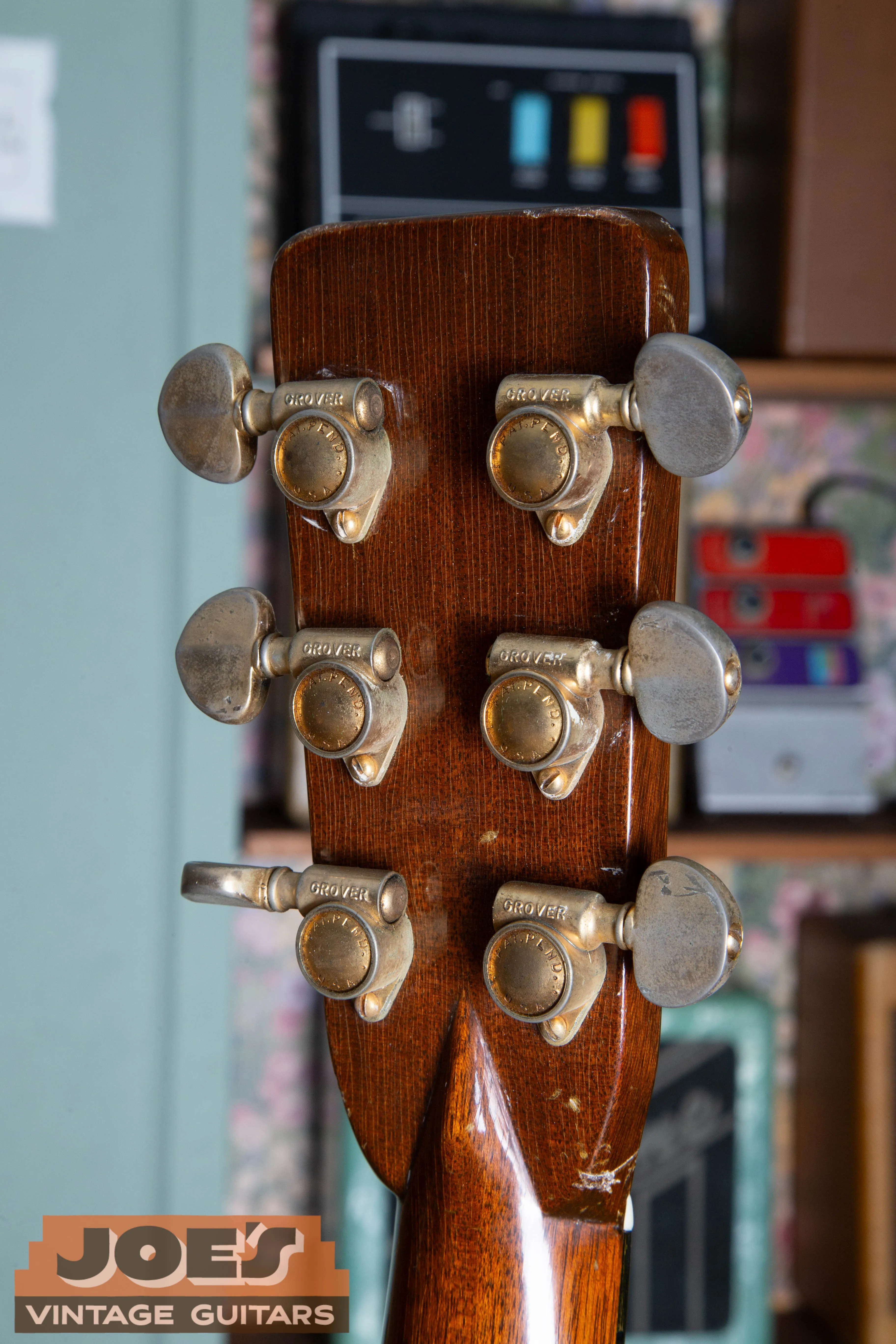 Close-up of original gold-plated tuners on a 1959 Martin D-28E vintage guitar. The gold plating shows an authentic aged patina, a premium feature that distinguishes the D-28E from the nickel-plated hardware on the D-18E.