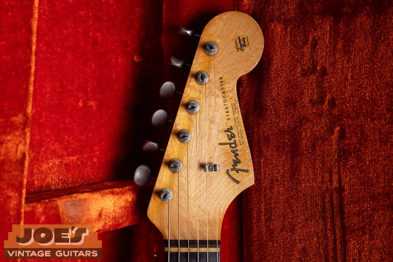 The small headstock of a 1962 Fender Stratocaster with the thin gold spaghetti logo and three patent numbers