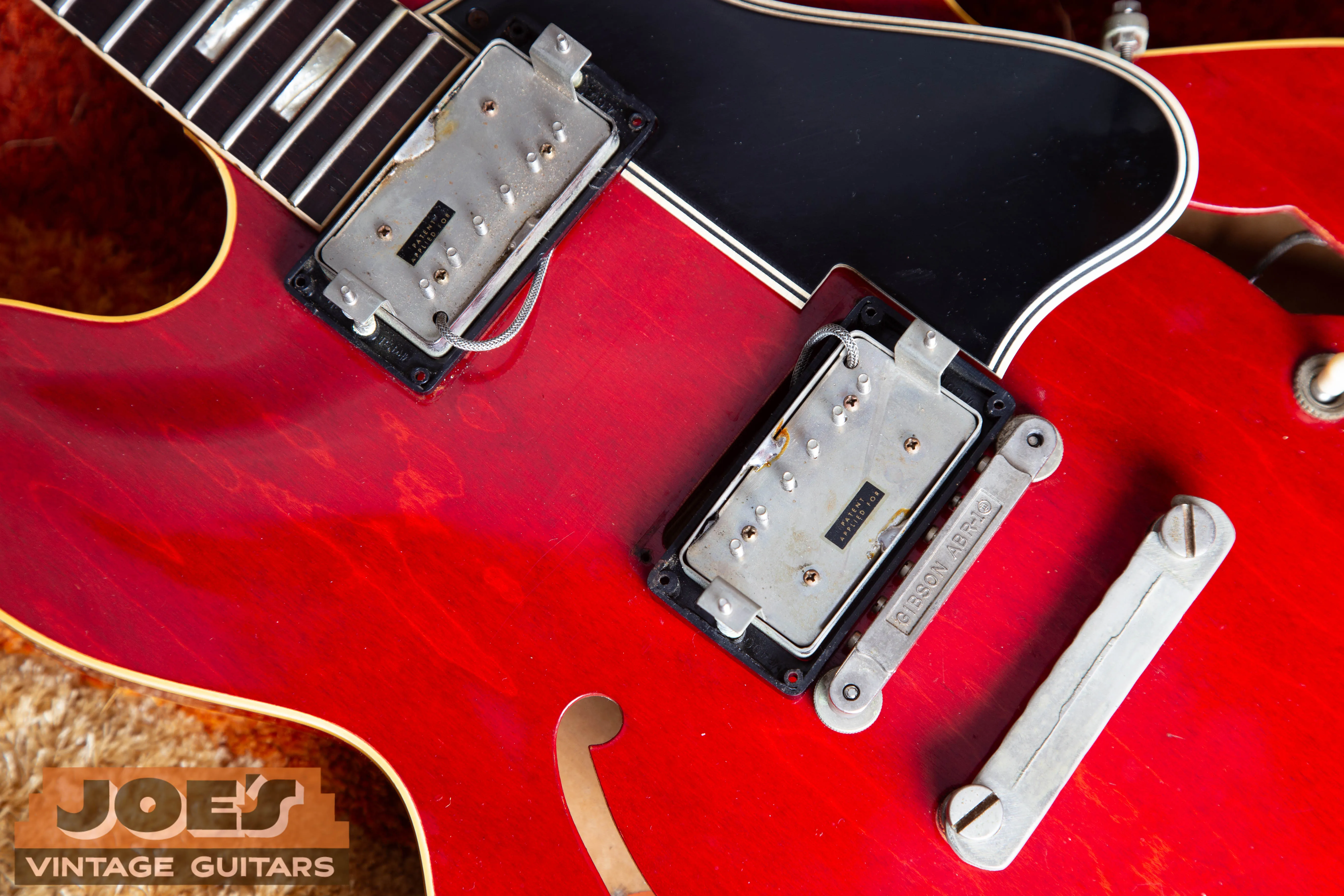 Close-up of a rare 1962 Gibson ES-335 pickup set featuring two original ‘Patent Applied For’ PAF humbuckers with intact decals, highlighting the 1962 transition from PAF to Patent Number pickups.