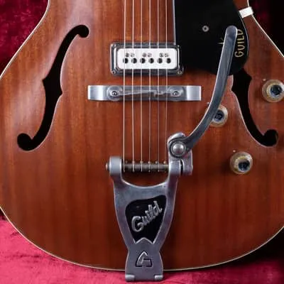 Detail of the refinished Guild Starfire showing the lower f-hole, bridge, vibrato tailpiece and light body binding.