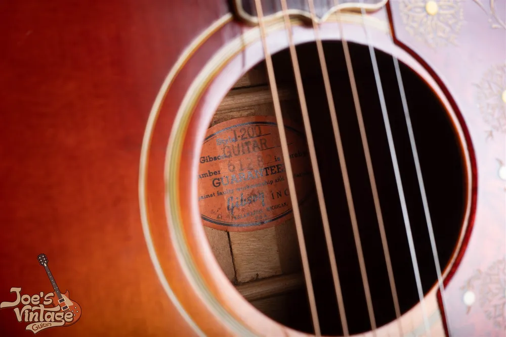 Orange oval J-200 label inside a 1962 Gibson acoustic guitar