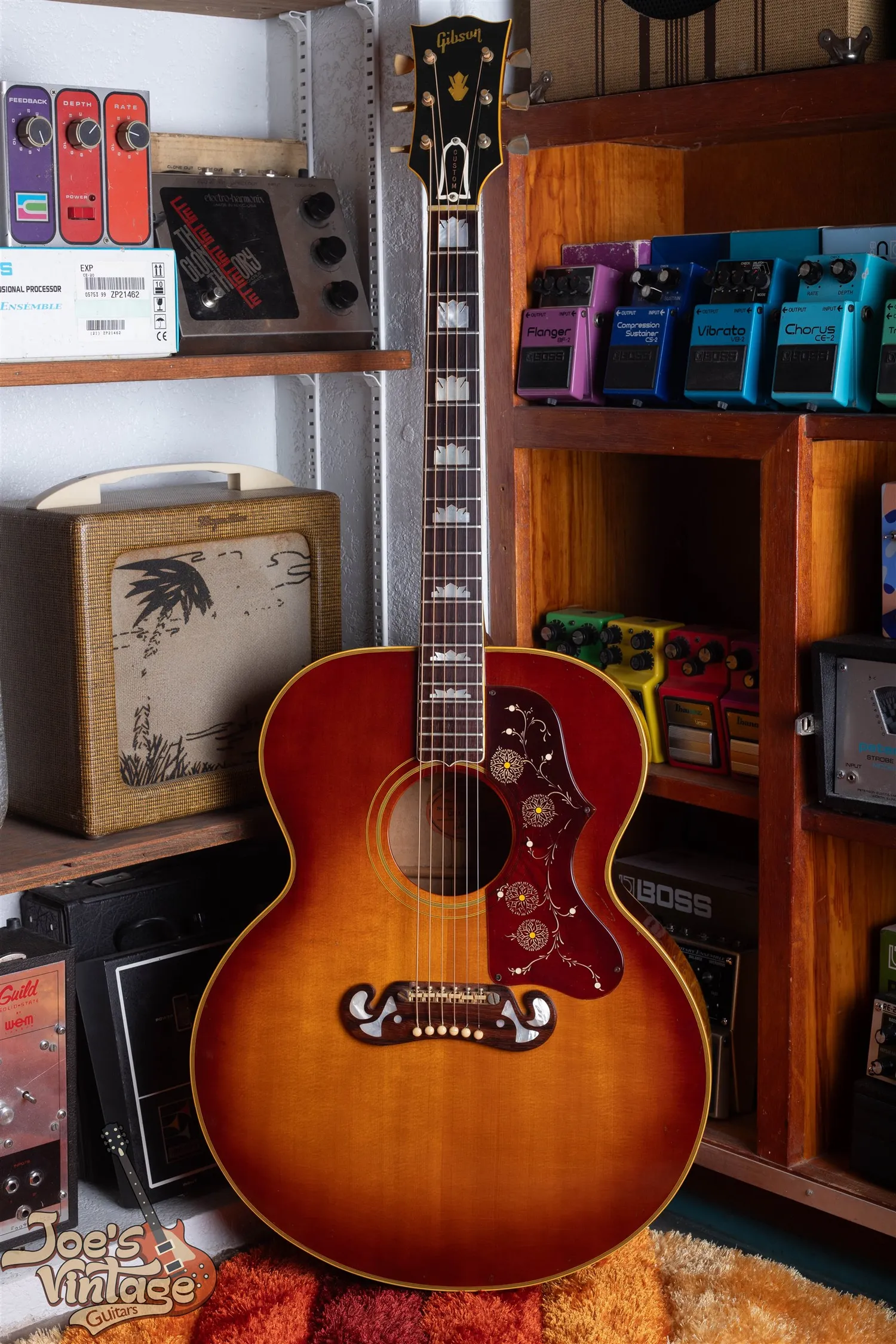 Full front of a 1962 Gibson J-200 in sunburst with a closed moustache bridge