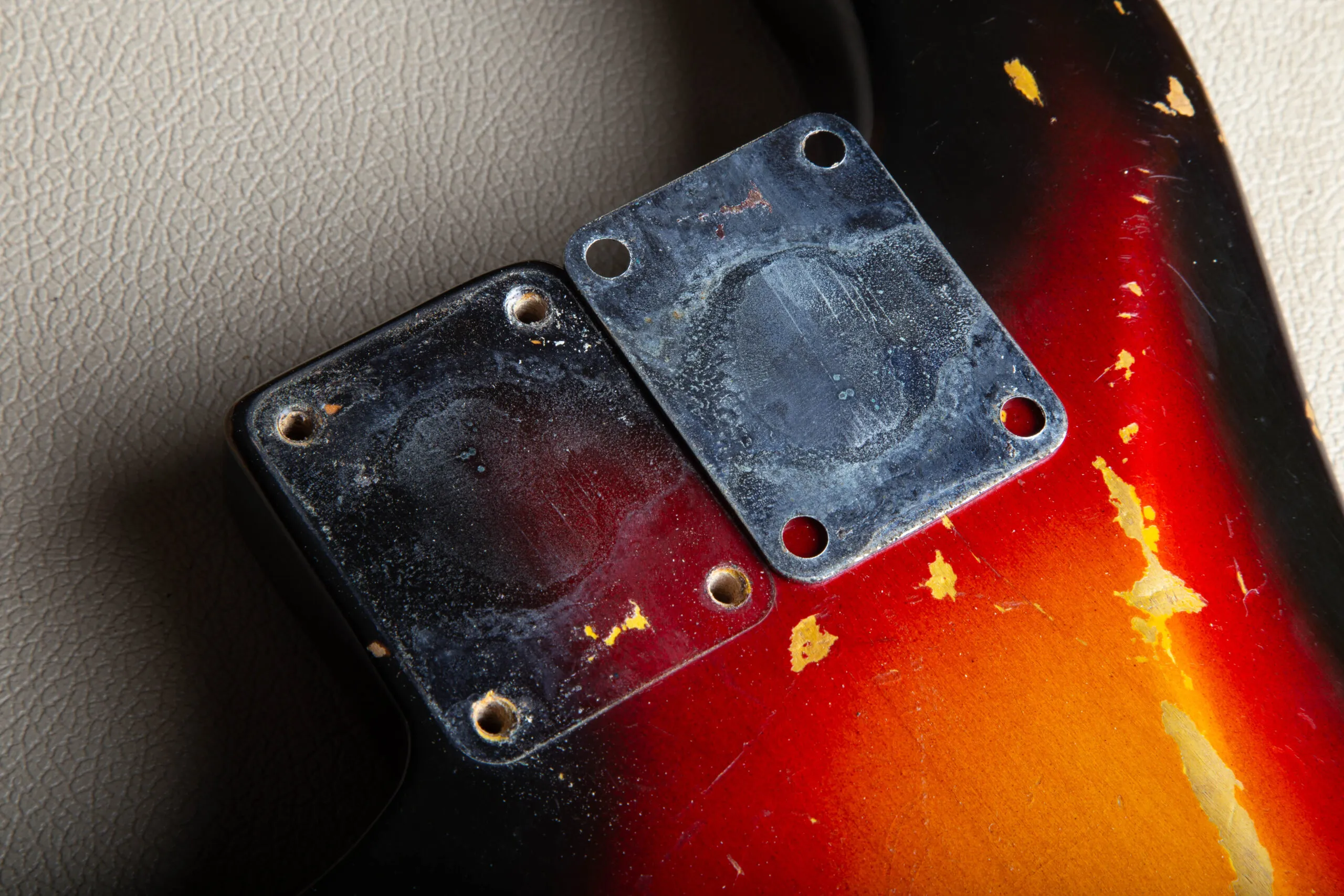 Back of the neck plate on a 1963 Fender Stratocaster matching the shadow it left in the body finish like a puzzle piece