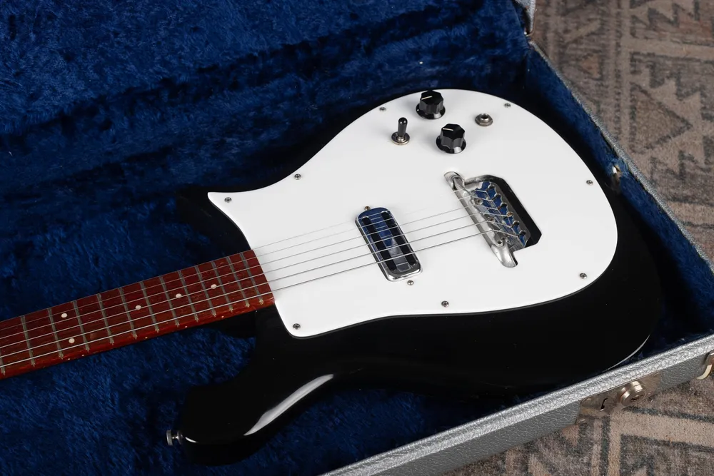 Archive-labeled 1964 Rickenbacker 425 in Jetglo: Angled front view. Multiple angles help distinguish finish glare from wear or damage.