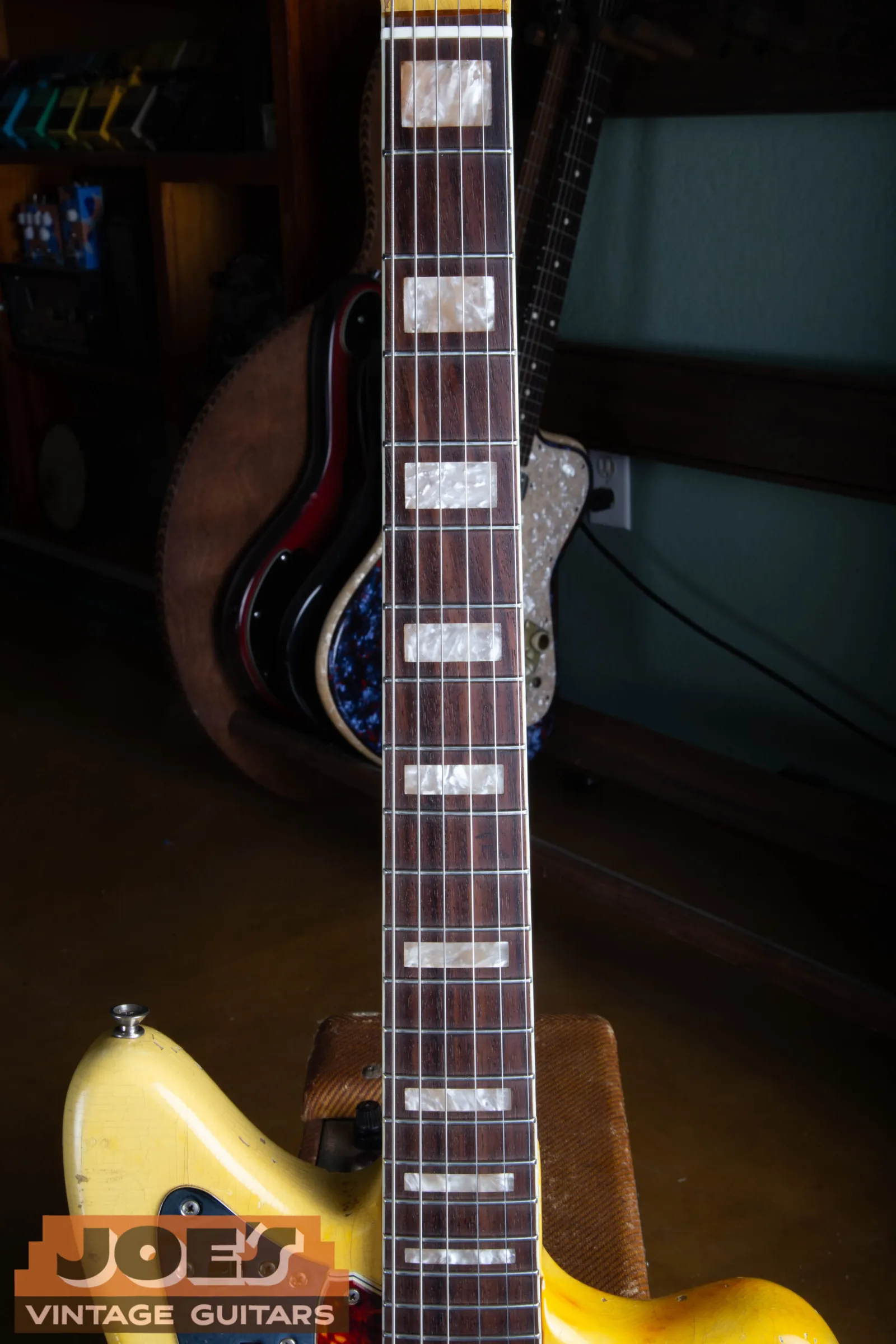 Pearloid block inlays on the bound rosewood fingerboard of a 1966 Fender Jaguar in Olympic White