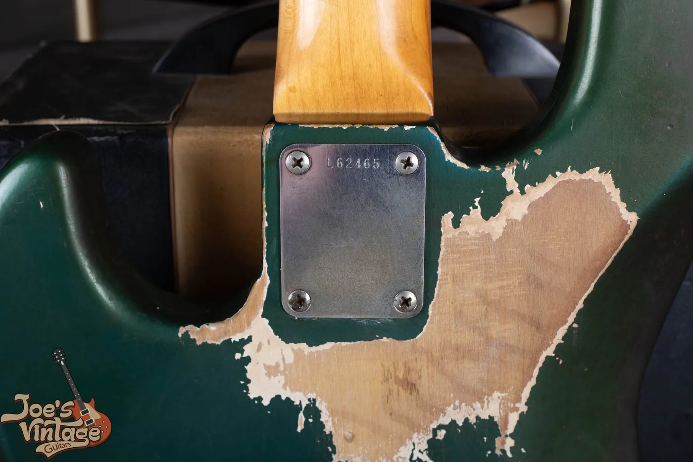 Back of a 1966 Fender Jazz Bass in Lake Placid Blue showing heavy belt wear where the blue has worn through to reveal a white undercoat beneath