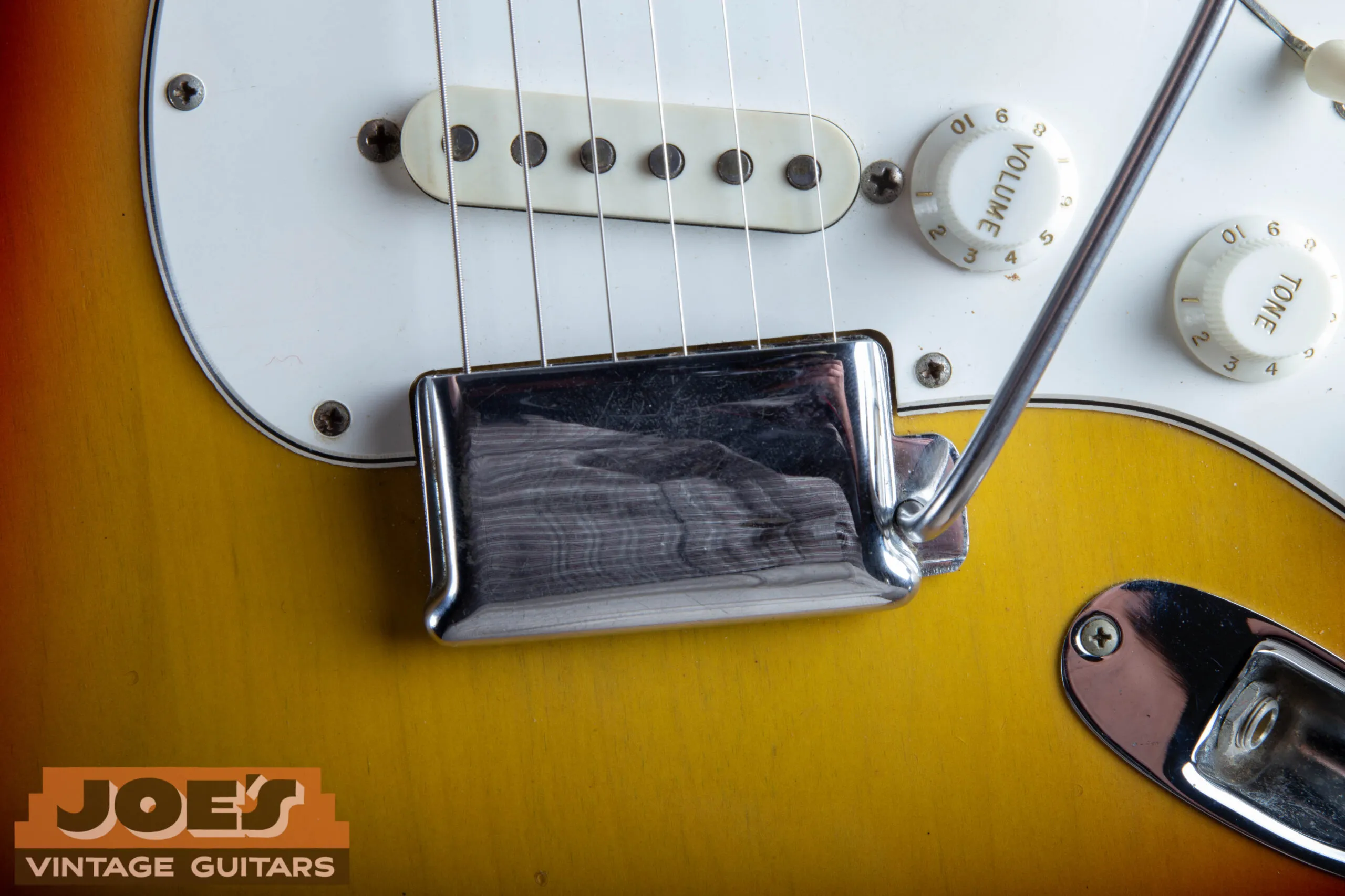 Chrome bridge cover (ashtray) clipped over the bridge of a 1966 Fender Stratocaster