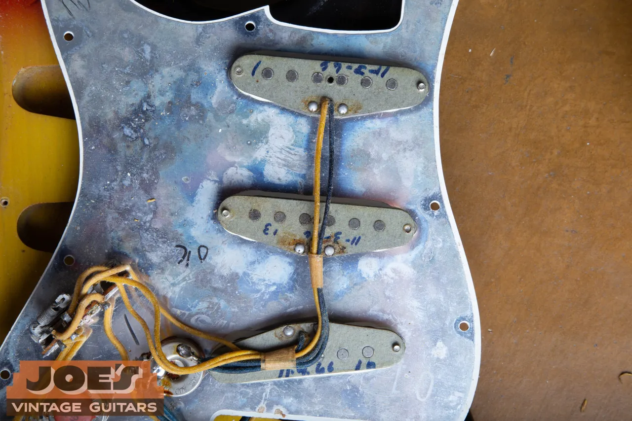A grey-bottom 1966 Fender Stratocaster pickup with the winder's date written on the bobbin