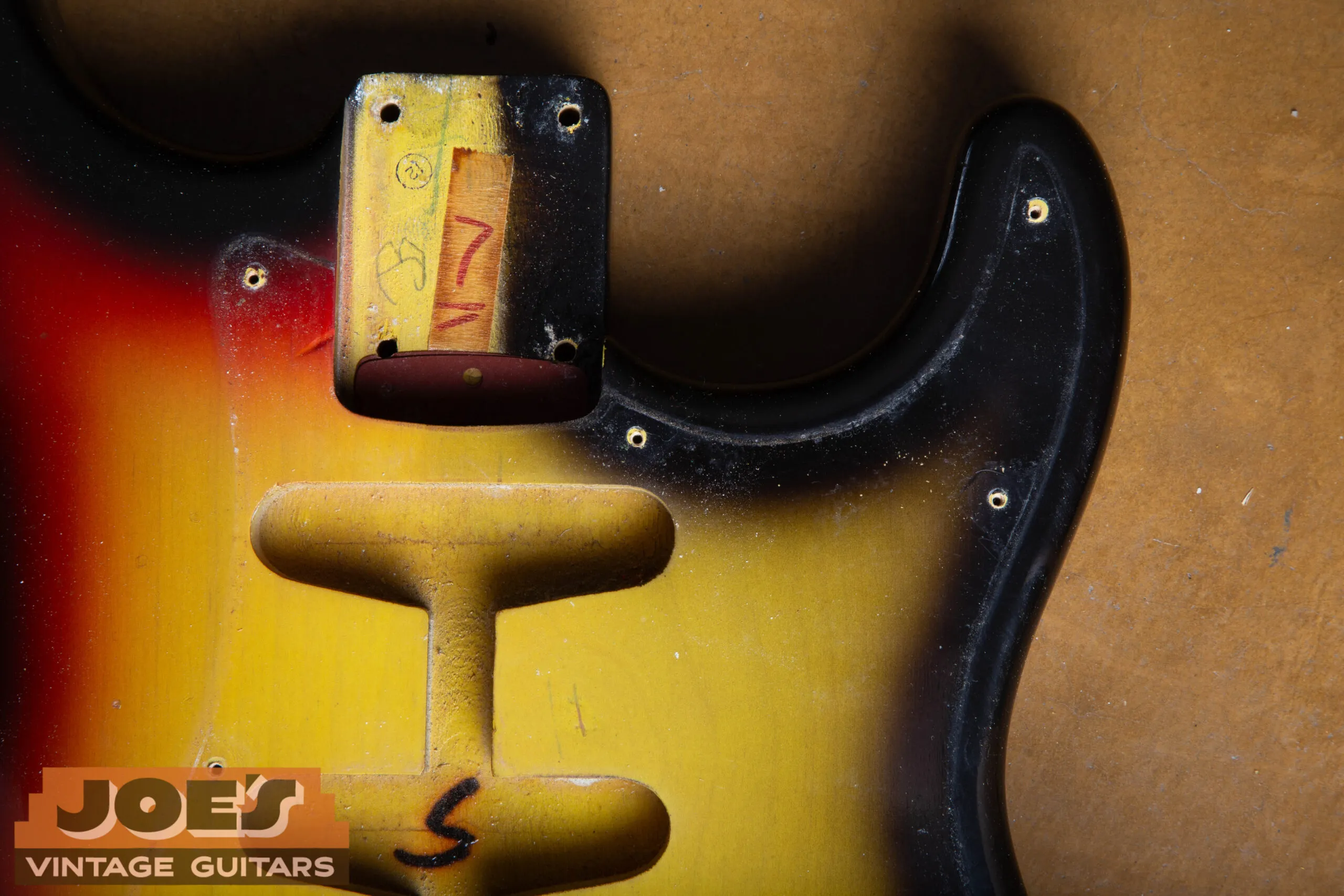Original 1966 Stratocaster sunburst showing the unsprayed area under the pickguard - the red band of the three-tone was never sprayed in the masked-off section, leaving a two-tone yellow-to-brown burst
