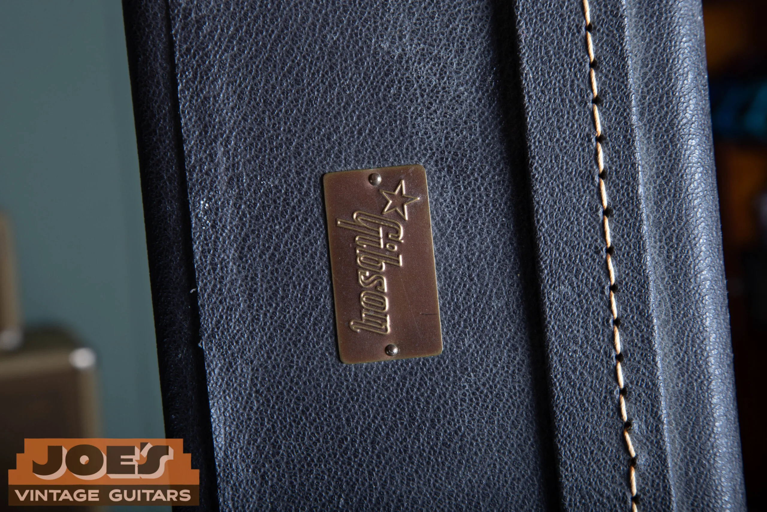 1966 Gibson ES-335 case exterior showing Gibson logo plaque, correct black hardshell case with period Gibson badge confirming mid-1960s case