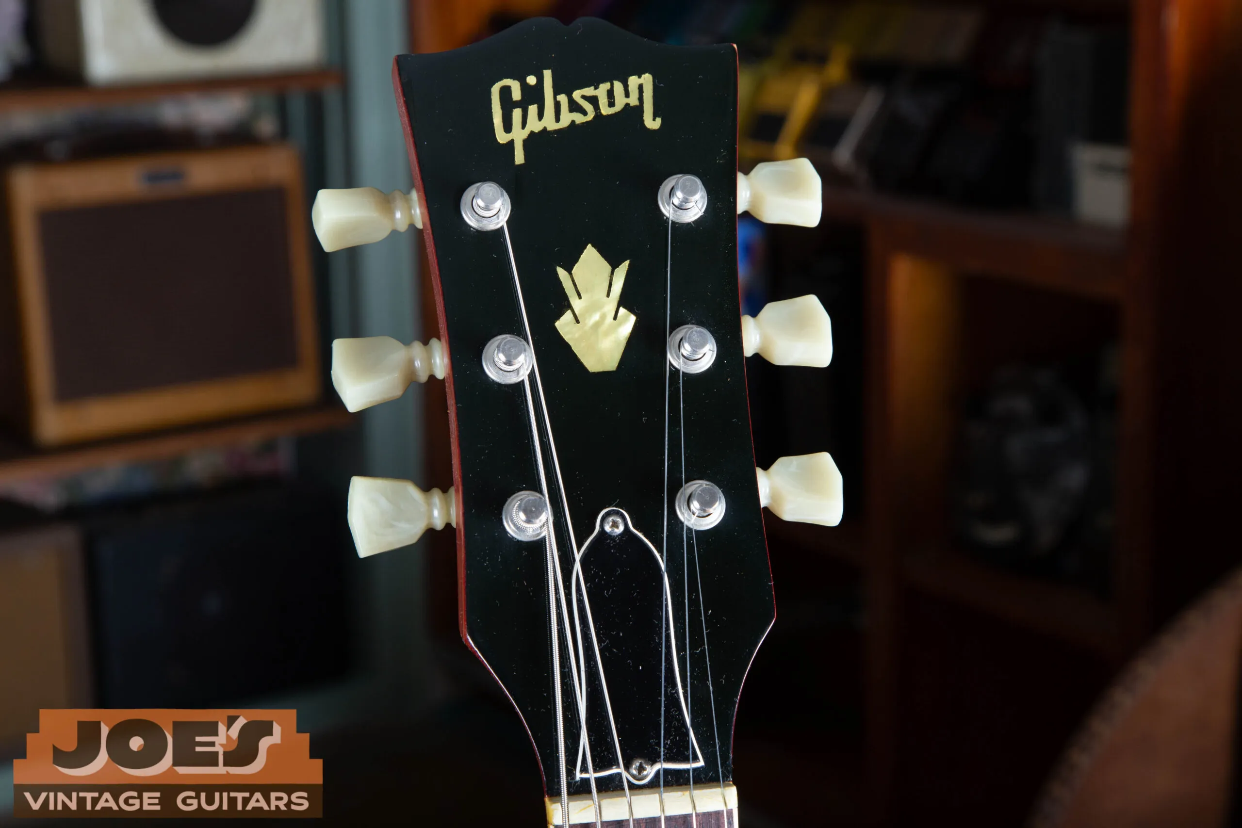1966 Gibson ES-335 headstock showing pearloid Gibson logo, crown inlay, blank bell-shaped truss rod cover, and Kluson double-line tuners