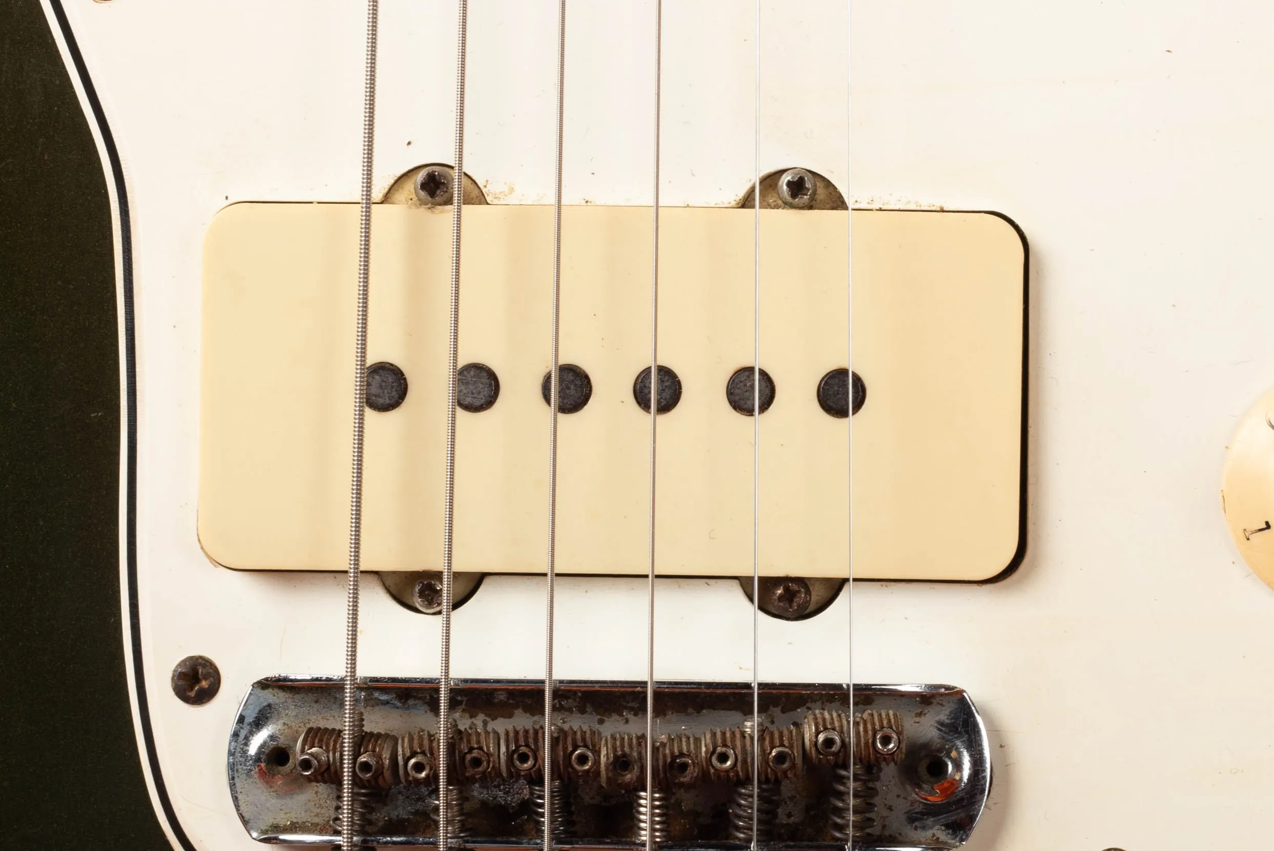 Fender Jazzmaster pickup close-up, wide flat single-coil pickup with chrome cover flush-mounted to pickguard, no exposed pole pieces, 1966 CBS-era example