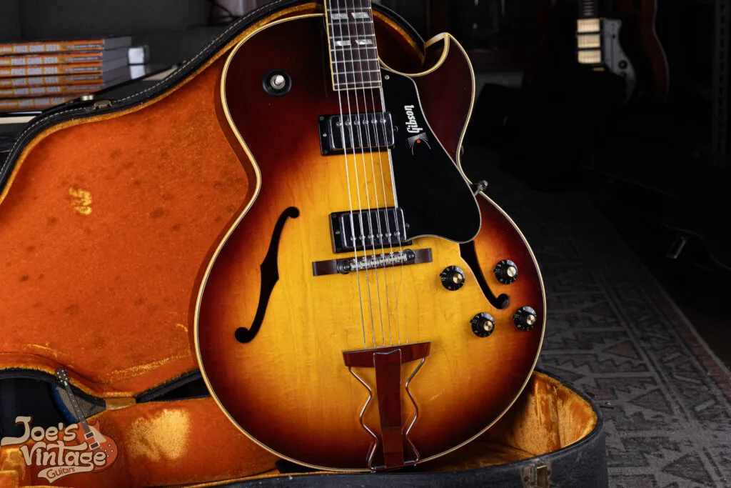 Shot of a 1968 Gibson ES-175D in Sunburst finish with two humbuckers, featuring a rare gold 'Gibson' logo on the pickguard and an original bridge with nylon saddles.