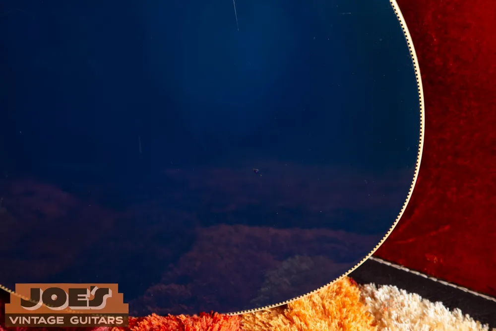 Joe’s 1968 Rickenbacker 4005 in Azureglo: Finish checking and wear on the body back. A clear close-up supports a specific condition description.