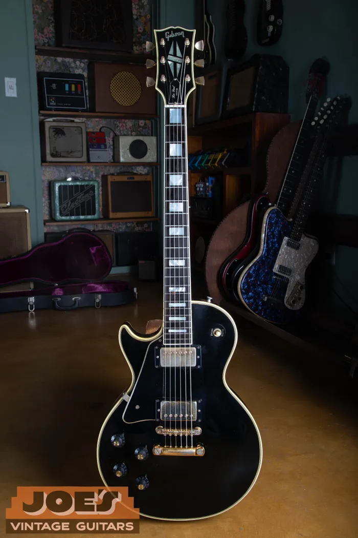 Full-length black 1969 Gibson Les Paul Custom with gold hardware