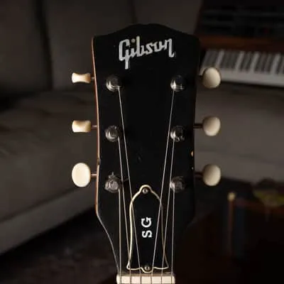 Close view of the black headstock face and Gibson logo on the refinished 1969 SG Special.