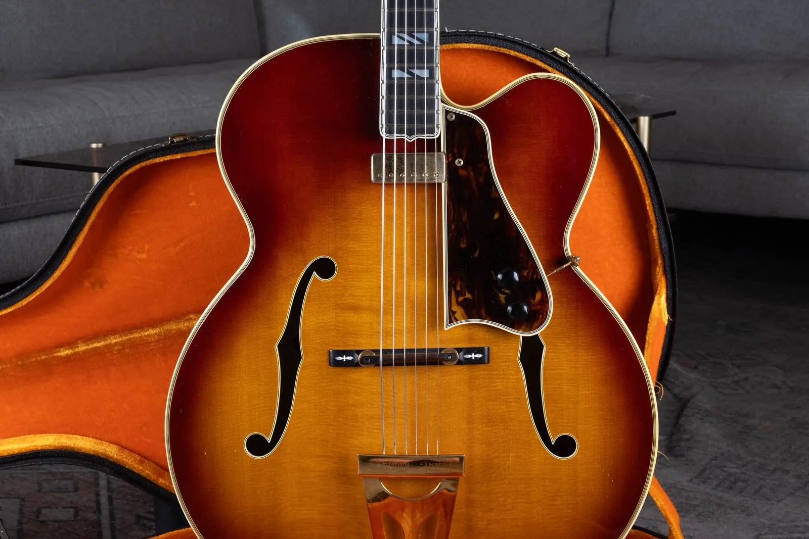 A 1969 Gibson Super 400 acoustic with an added Johnny Smith pickup, in an orange-lined case.