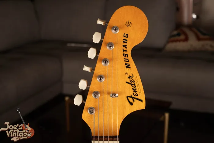 Headstock of a 1971 Fender Mustang showing the large CBS-era headstock with the bold black Fender logo and Mustang model name