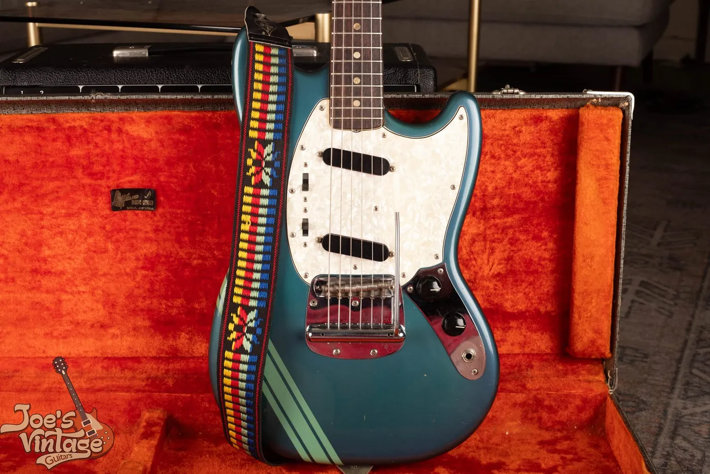 Full front view of a 1971 Fender Competition Mustang in Competition Blue with a diagonal racing stripe and a pearloid pickguard