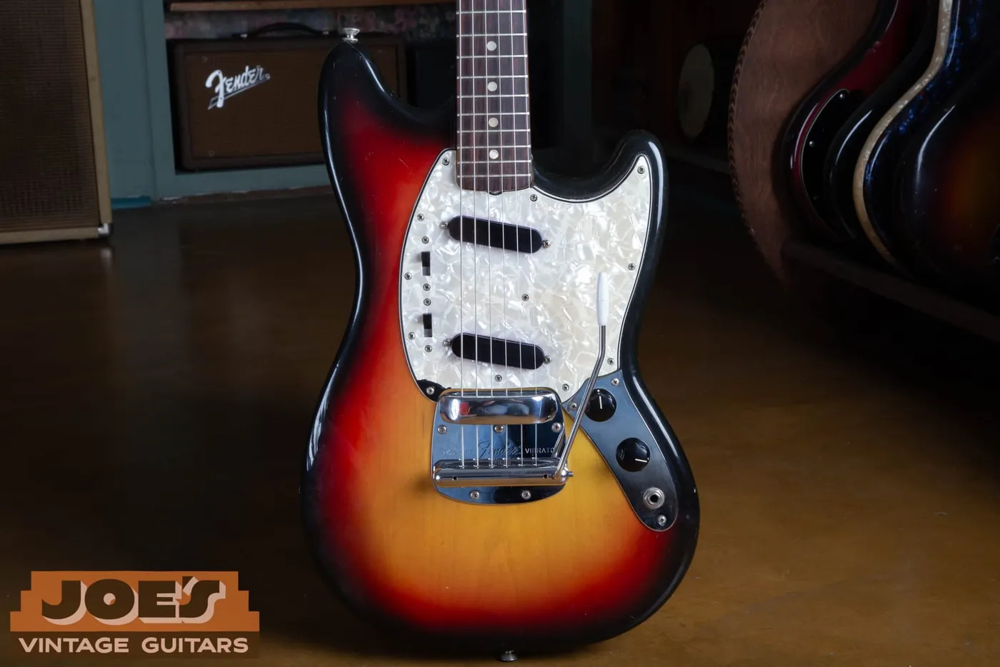 Front of a 1972 Fender Mustang in three-colour sunburst with a pearloid pickguard and the Dynamic Vibrato