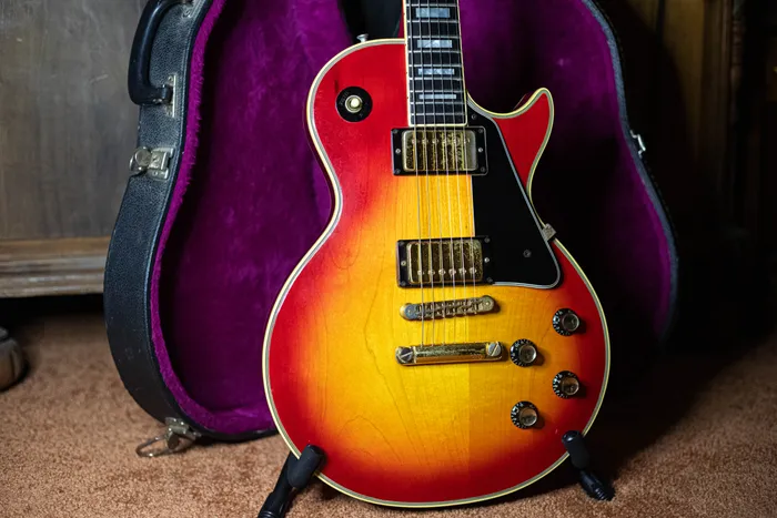 Cherry sunburst 1976 Gibson Les Paul Custom body with two covered humbuckers and gold hardware.